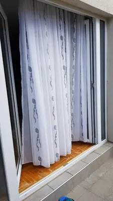 a window with white curtains in a room at Čar30 Kraljevi čardaci in Kopaonik