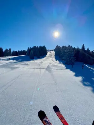 a pair of skis standing on a snow covered road at Duplex Vidik B30 - 85m2 in Kopaonik
