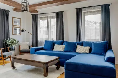 a living room with a blue couch and a coffee table at Duplex Vidik B30 - 85m2 in Kopaonik