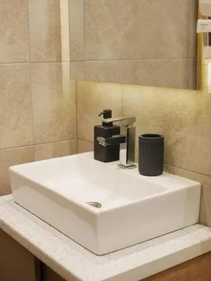 a white sink in a bathroom with a mirror at DeltaLux apartmani Milmari Kopaonik in Kopaonik
