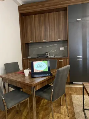 a kitchen with a wooden table with a laptop on it at Apartman Milosavljevic-President Kop in Kopaonik