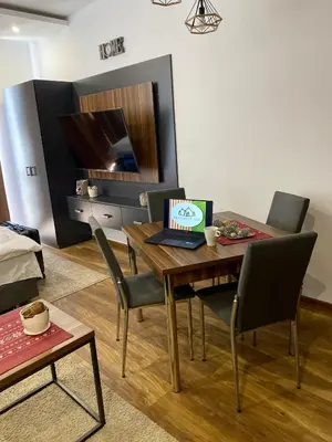 a dining room with a table with a laptop on it at Apartman Milosavljevic-President Kop in Kopaonik