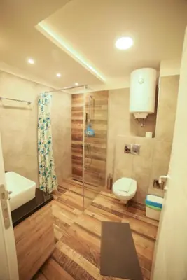 a bathroom with a toilet and a glass shower at Milmari Premier40 in Kopaonik