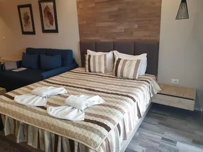a bedroom with a large bed with towels on it at Milmari Premier40 in Kopaonik