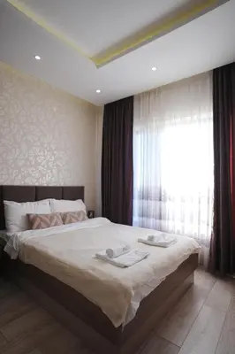 a bedroom with a large bed and a window at VitaDea Milmari Kopaonik in Kopaonik