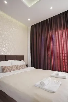 a bedroom with two white towels on a bed at VitaDea Milmari Kopaonik in Kopaonik