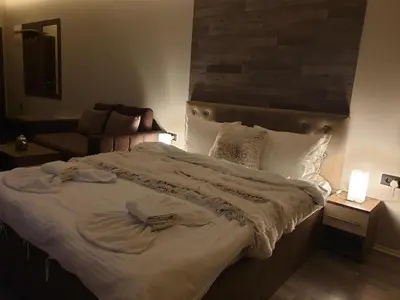 a bedroom with a large bed and a couch at Milmari Premier05 in Kopaonik