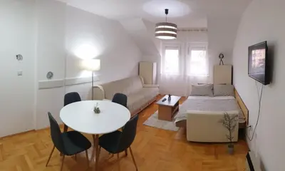 a living room with a table and a couch at Apartman Ristić 6 in Soko Banja