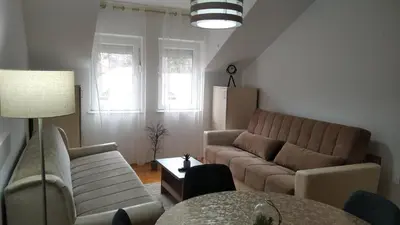 a living room with a couch and a table at Apartman Ristić 6 in Soko Banja