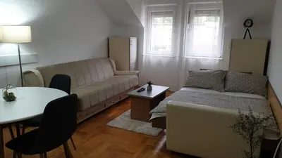 a living room with a couch and a table at Apartman Ristić 6 in Soko Banja