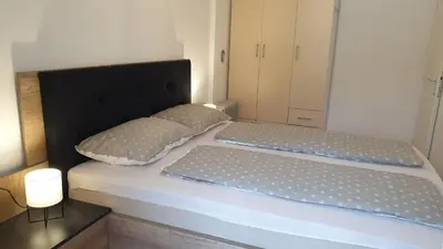 a bed with two pillows on top of it at Apartman Ristić 6 in Soko Banja