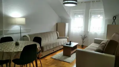 a living room with a couch and a table at Apartman Ristić 6 in Soko Banja