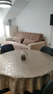 a living room with a table and a couch at Apartman Ristić 6 in Soko Banja