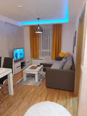 a living room with a couch and a tv at apartman Kraljevi čardaci Sadikovic sa garažom in Kopaonik