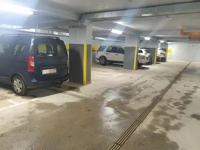 a parking garage with several cars parked in it at apartman Kraljevi čardaci Sadikovic sa garažom in Kopaonik