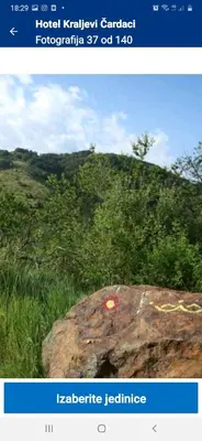 a screenshot of a picture of a rock in a field at apartman Kraljevi čardaci Sadikovic sa garažom in Kopaonik