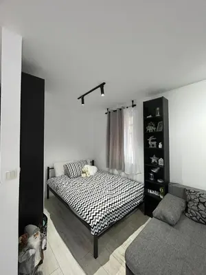 a bedroom with a bed and a book shelf at Vila Vedrana Apartman Nedeljkovic in Brzeće