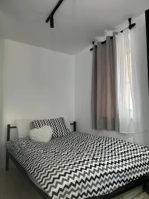a bedroom with a black and white bed with a window at Vila Vedrana Apartman Nedeljkovic in Brzeće