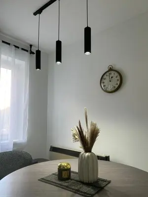 a dining room table with a clock and a pumpkin at Vila Vedrana Apartman Nedeljkovic in Brzeće