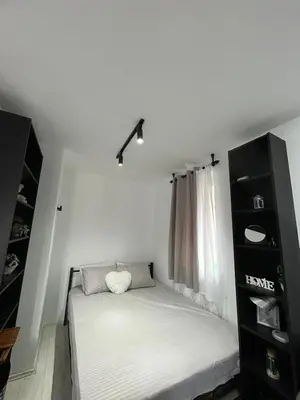 a small bed in a room with a window at Vila Vedrana Apartman Nedeljkovic in Brzeće