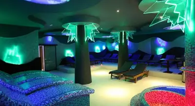 a room with blue and green lights and a couch at Apartman Kraljevi cardaci 5b-32 in Kopaonik