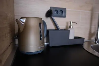 a toaster sitting on a counter next to a sink at Ski & Spa Apartment N34 Milmari Resort Kopaonik in Kopaonik