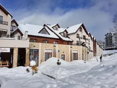 a group of buildings covered in snow in front at Ski & Spa Apartment N34 Milmari Resort Kopaonik in Kopaonik