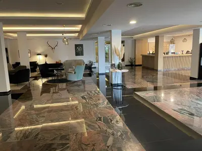 a lobby with a living room and a dining room at Apartman DreamHome in Vrnjačka Banja