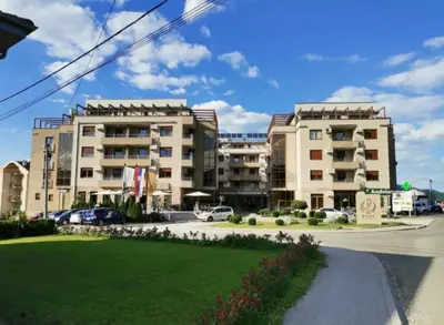 a street with two large buildings in a city at Apartman DreamHome in Vrnjačka Banja