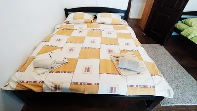 a bed with a quilt on it in a room at Apartman Draškovic - Goč in Biserske Kuće