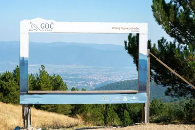a sign on top of a hill with a view at Apartman Draškovic - Goč in Biserske Kuće