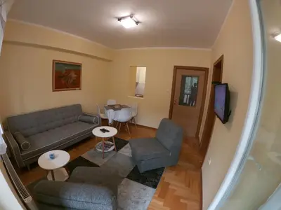 a living room with a couch and a table at Apartman Djole in Brzeće