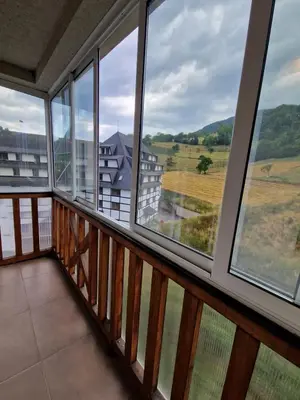 a balcony with windows and a view of the countryside at Apartman Djole in Brzeće