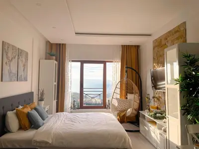 a bedroom with a bed with a view of the ocean at Apartmani Madera in Kopaonik