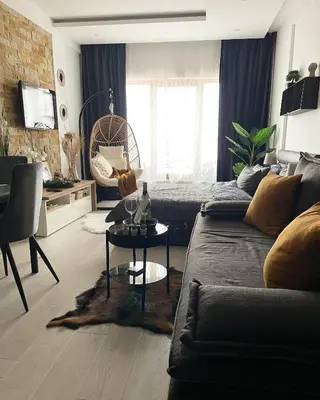 a living room with a couch and a table at Apartmani Madera in Kopaonik