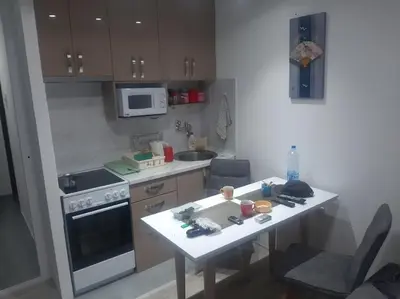 a kitchen with a table and a stove and a sink at Bele staze 59 in Brus