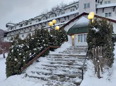 a snow covered staircase in front of a building at Bele staze 59 in Brus