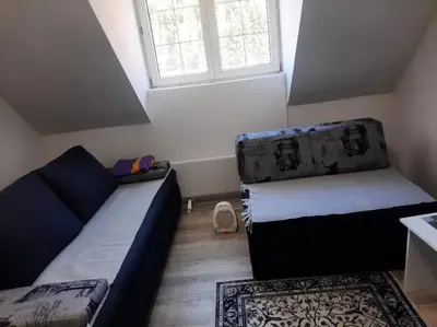 a small room with a couch and a window at Bele staze 59 in Brus