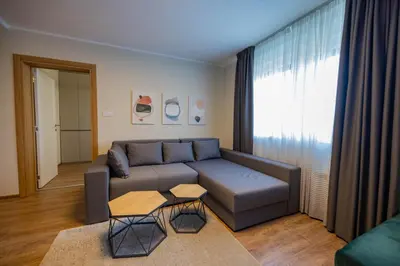 a living room with a couch and a table at Omega Apartments in Vrnjačka Banja