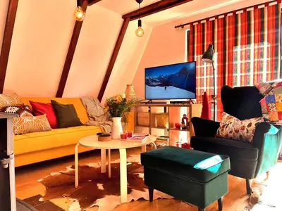 a living room with a yellow couch and a table at Kuća na Kopaoniku - Rani mraz in Kopaonik