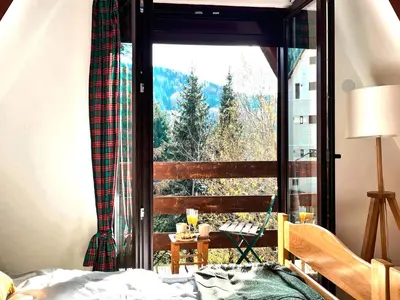 a bedroom with a window with a mountain view at Kuća na Kopaoniku - Rani mraz in Kopaonik
