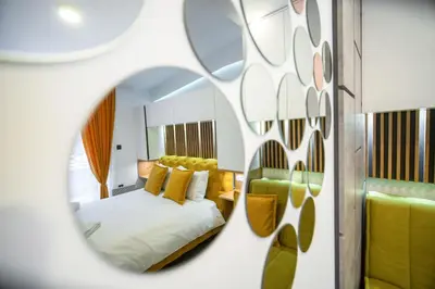 a bedroom with a bed and a mirror at Pleasure Lux MILMARI-Kopaonik in Kopaonik