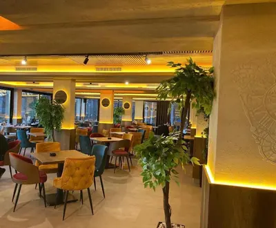a dining room with tables and chairs and a restaurant at Pleasure Lux MILMARI-Kopaonik in Kopaonik