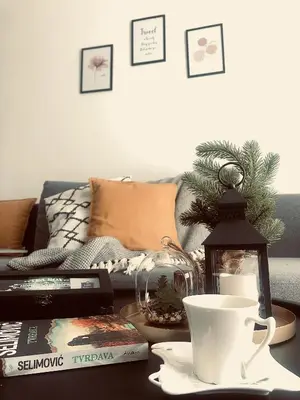 a living room with a coffee table with a christmas tree at Kopaonik Milmari Apartment N95 in Kopaonik