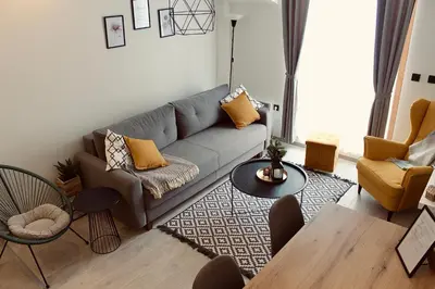 a living room with a couch and a table at Kopaonik Milmari Apartment N95 in Kopaonik