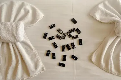 a white dress on a bed with black beads at Milmari Premier 13 in Kopaonik