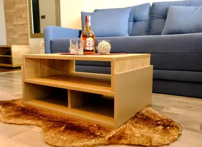 a coffee table with a bottle of alcohol on it at Milmari Premier 13 in Kopaonik