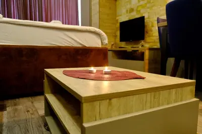a table with two candles on top of a bed at Milmari Premier 13 in Kopaonik