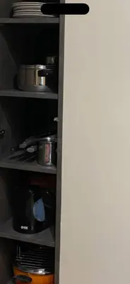 a kitchen shelf with pots and pans and plates at Apartman Šmizla N lux - Milmari Resort in Kopaonik