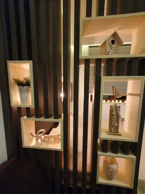 a room with three shelves with items on a wall at Apartman Šmizla N lux - Milmari Resort in Kopaonik